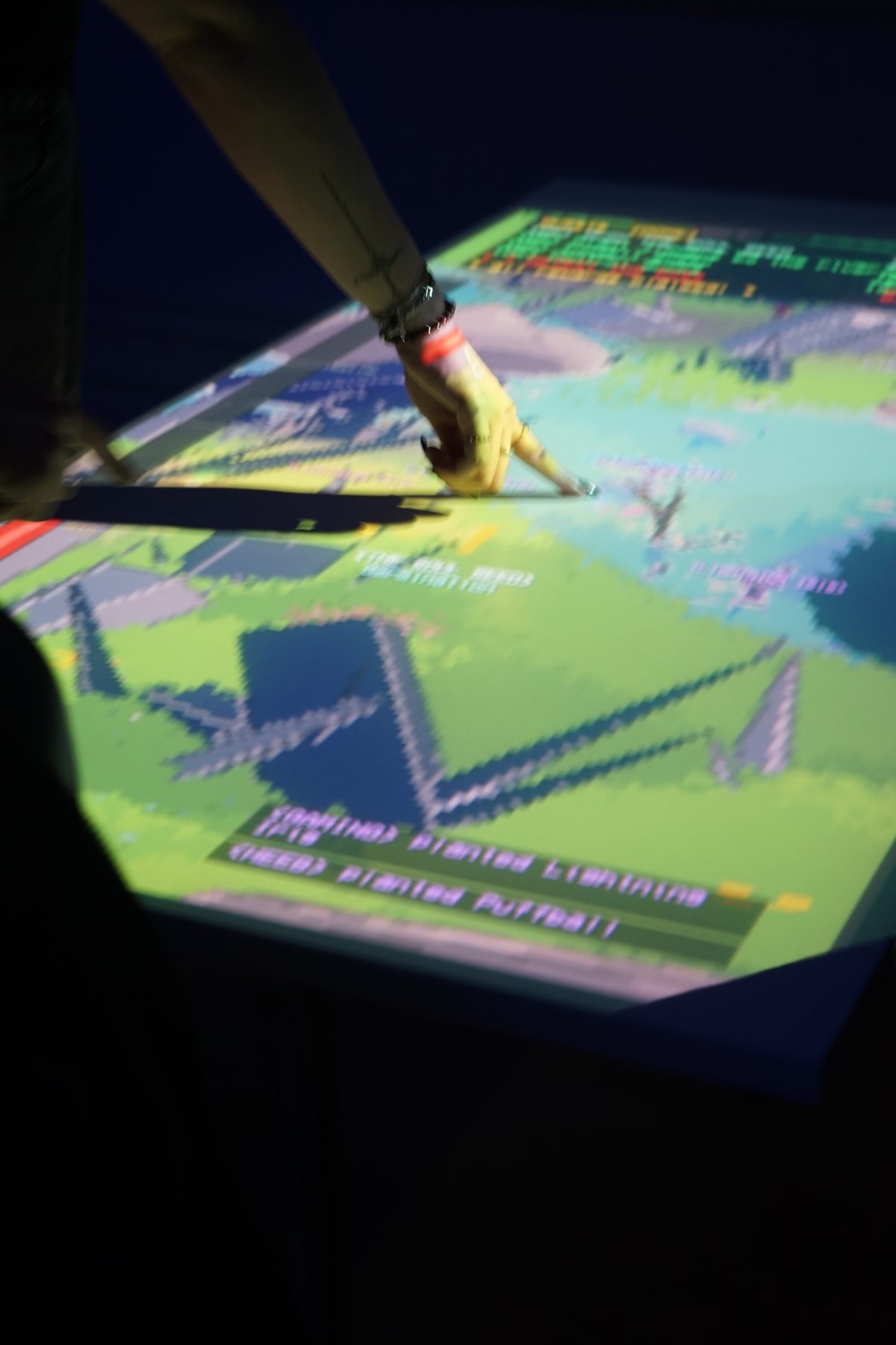 A hand reaching onto the projected surface