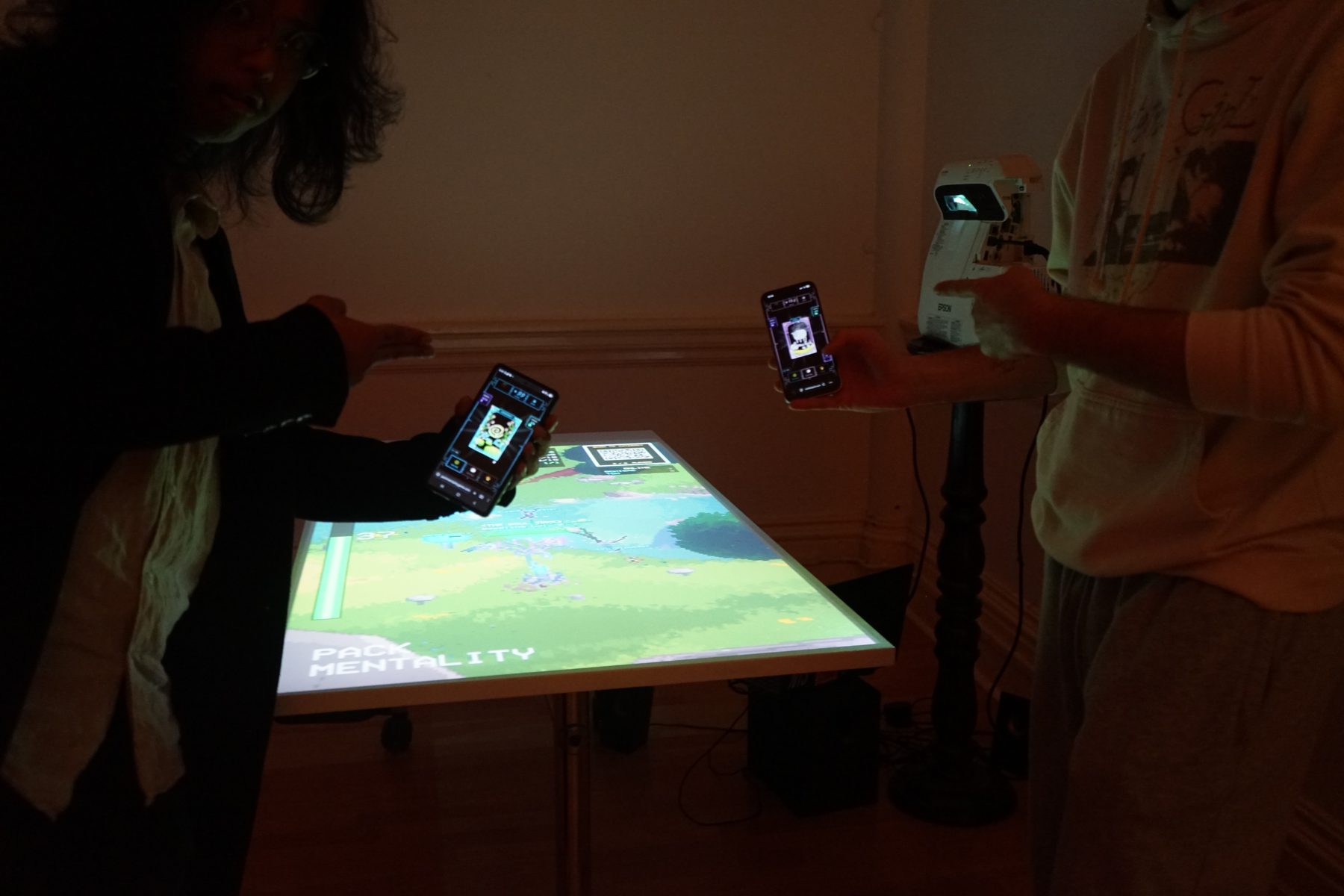 Players either side of the table, projector on its stand